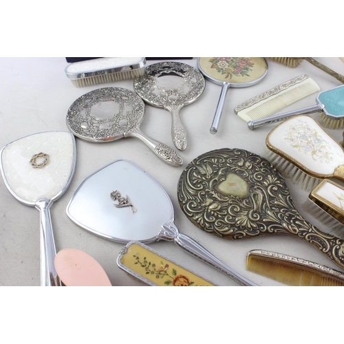 127 - Thirty assorted vintage vanity items to include mirrors, brushes etc.