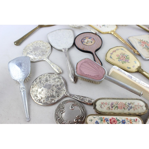 128 - Thirty assorted vintage vanity items to include mirrors, brushes etc.