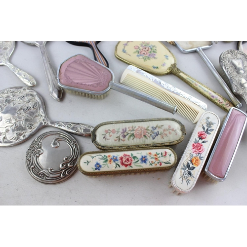 128 - Thirty assorted vintage vanity items to include mirrors, brushes etc.