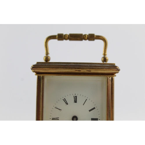 187 - A vintage St James London key wind brass cased mantel clock