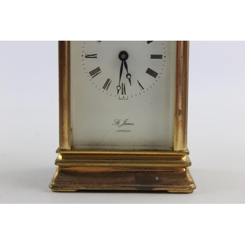 187 - A vintage St James London key wind brass cased mantel clock