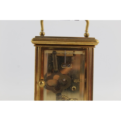 187 - A vintage St James London key wind brass cased mantel clock