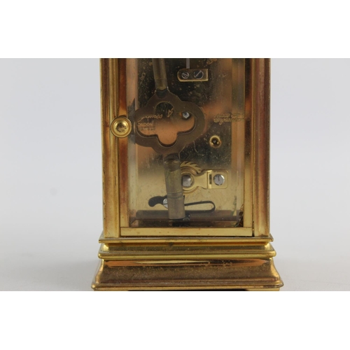 187 - A vintage St James London key wind brass cased mantel clock