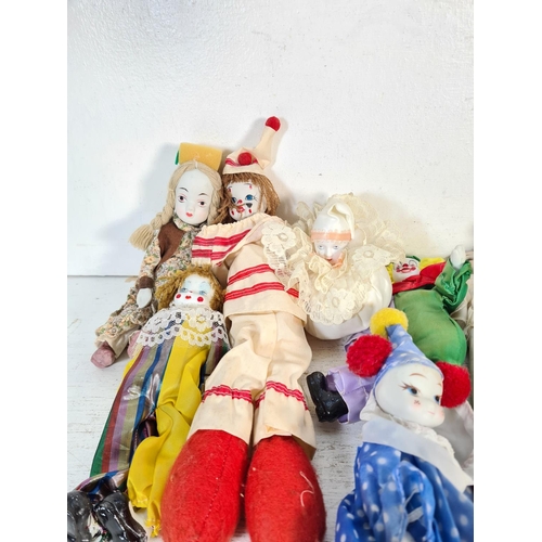 108D - A collection of porcelain headed dolls to include clowns etc.