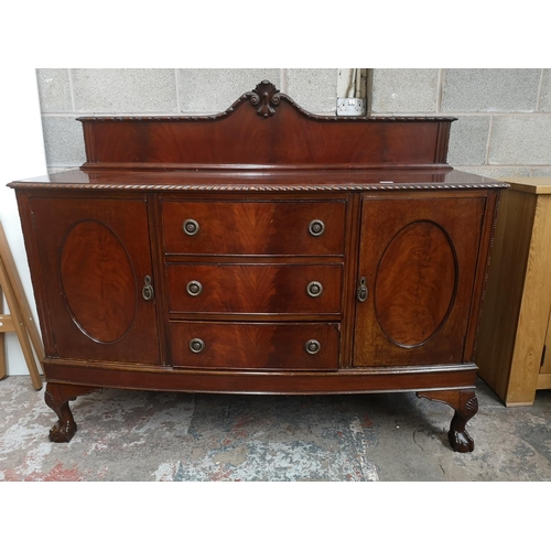 340 - A Georgian style mahogany bow fronted sideboard with carved acanthus leaf gallery back, two outer cu... 