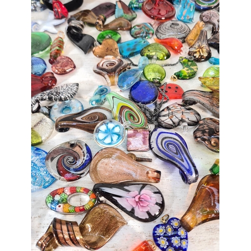 109 - A large collection of art glass necklace pendants and various beads to include Murano etc. Together ... 