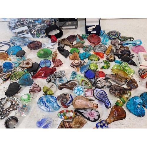 109 - A large collection of art glass necklace pendants and various beads to include Murano etc. Together ... 