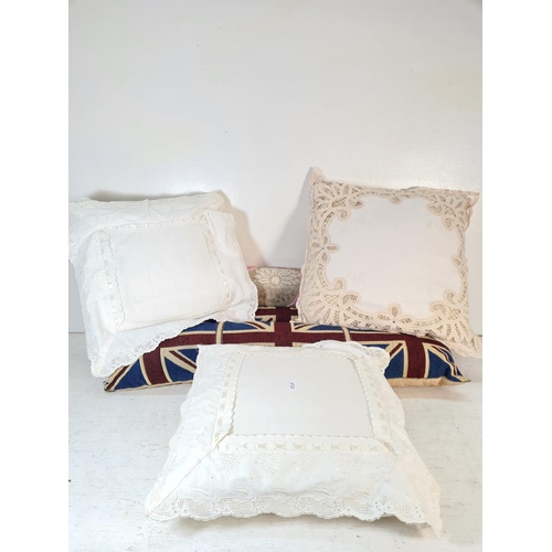 121 - Six items, three white cushions and three draft excluders