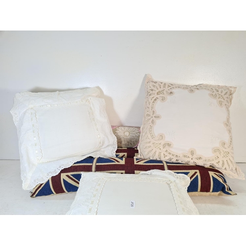 121 - Six items, three white cushions and three draft excluders