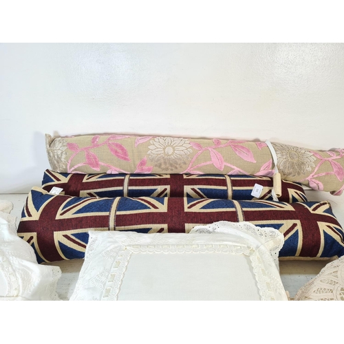 121 - Six items, three white cushions and three draft excluders