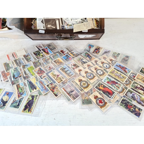 135 - A large collection of assorted vintage postcards, First Day covers and collectors cards