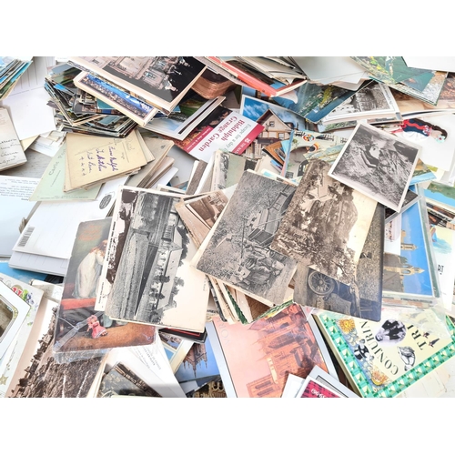 141 - A large collection of antique and vintage postcards