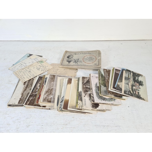 141 - A large collection of antique and vintage postcards