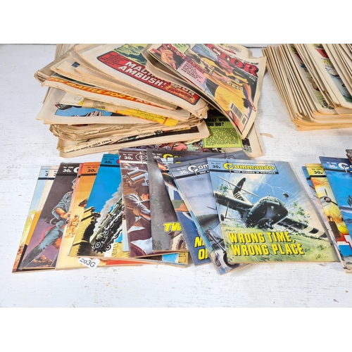 157 - A large collection of vintage Commando and Victor comics