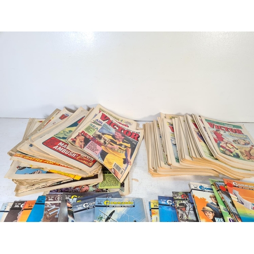 157 - A large collection of vintage Commando and Victor comics