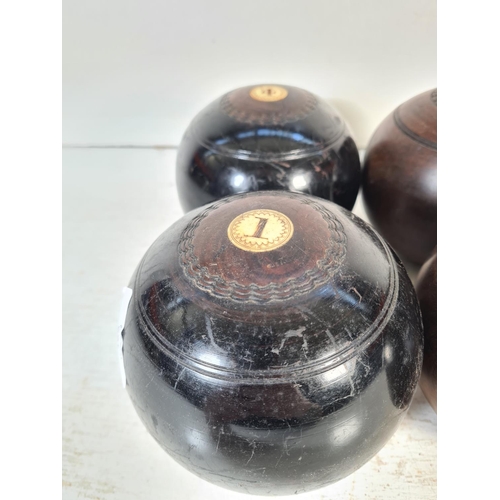 169 - Two pairs of early 20th century lignum vitae and bone bowls