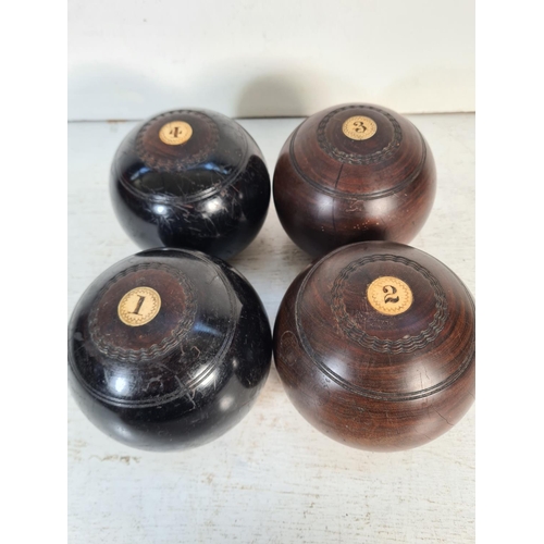 169 - Two pairs of early 20th century lignum vitae and bone bowls