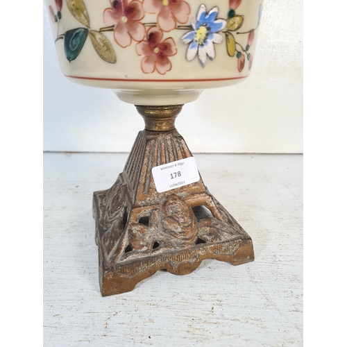 178 - A 19th century cast iron and ceramic oil lamp with hand painted floral design - approx. 54cm high