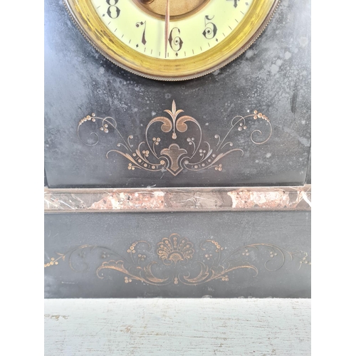 185 - A 19th century French slate mantle clock with enamel face and pair of slate and bronze garnitures