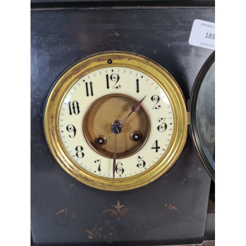 185 - A 19th century French slate mantle clock with enamel face and pair of slate and bronze garnitures