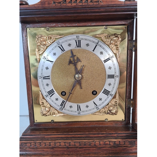 191 - A 19th century style carved oak cased chiming mantle clock with key and pendulum - approx. 32cm high... 