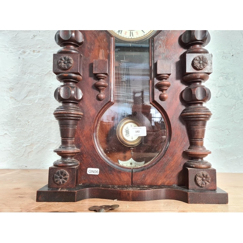 192 - A Victorian walnut cased Vienna wall clock with enamel face, key and pendulum - approx. 56.5cm high ... 