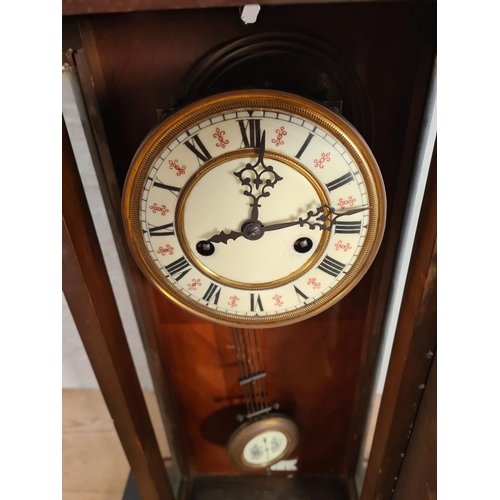 192 - A Victorian walnut cased Vienna wall clock with enamel face, key and pendulum - approx. 56.5cm high ... 