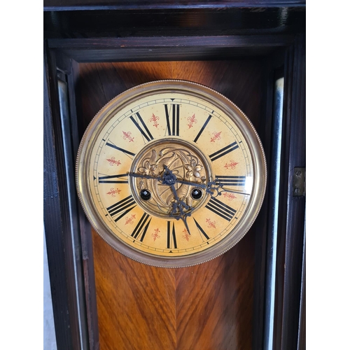 193 - A Victorian mahogany cased Vienna wall clock with enamel face, key and pendulum - approx. 82cm high ... 