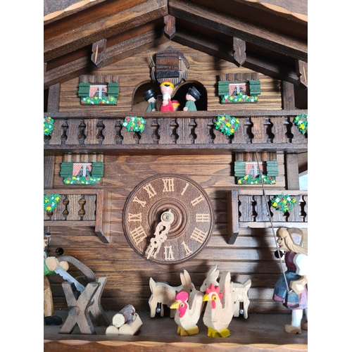 194 - A 19th century style oak cased cuckoo clock with weights