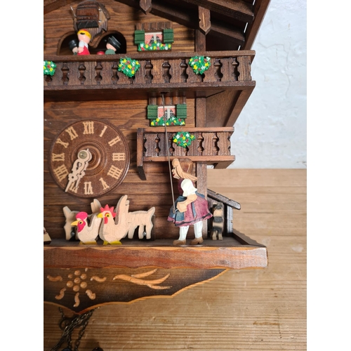 194 - A 19th century style oak cased cuckoo clock with weights