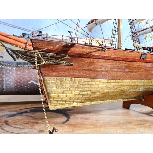 198 - Two scratch built wooden model ships on stands to include The Cutty Sark etc. - largest approx. 65cm... 