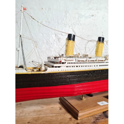 205 - A kit built and hand painted wooden model of The RMS Titanic on wooden plinth - approx. 34cm high x ... 