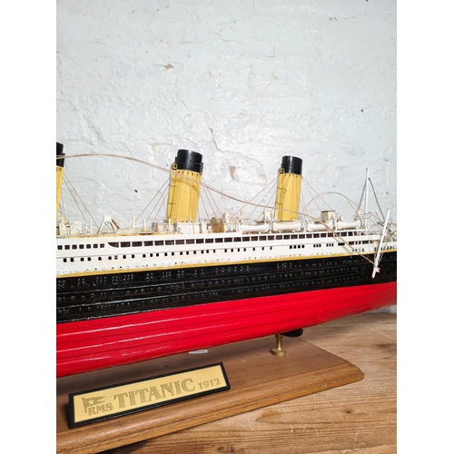 205 - A kit built and hand painted wooden model of The RMS Titanic on wooden plinth - approx. 34cm high x ... 