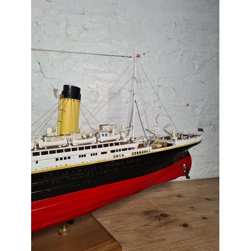 205 - A kit built and hand painted wooden model of The RMS Titanic on wooden plinth - approx. 34cm high x ... 