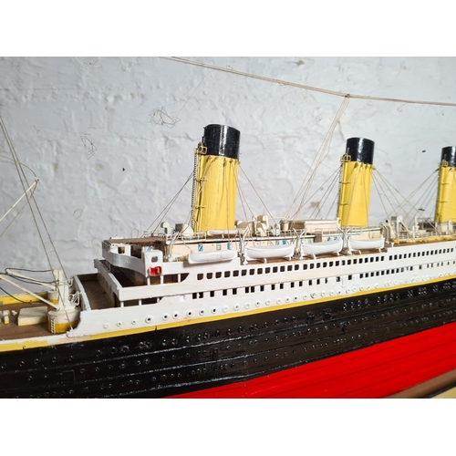 205 - A kit built and hand painted wooden model of The RMS Titanic on wooden plinth - approx. 34cm high x ... 