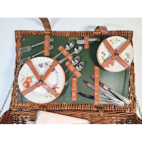 207 - A vintage Optima wicker picnic basket containing cutlery, plates etc.