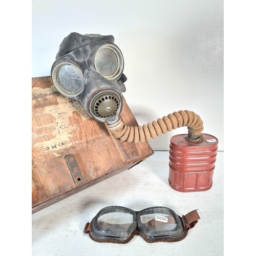 215 - Two pieces of militaria comprising WWII B W&M Ltd no.4A Canadian military issued respirator mask dat... 