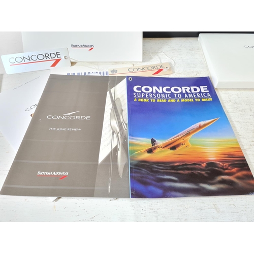 224 - A collection of Concorde related items to include cased Royal Mint Rise to the Challenge silver proo... 