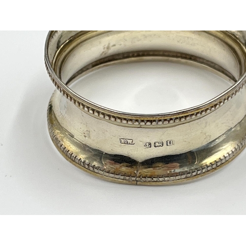 1229 - Six items of hallmarked Birmingham silver comprising hand mirror dated 1929, three napkin rings, one... 