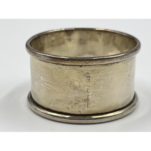 1229 - Six items of hallmarked Birmingham silver comprising hand mirror dated 1929, three napkin rings, one... 