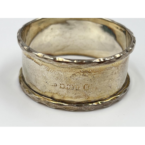 1229 - Six items of hallmarked Birmingham silver comprising hand mirror dated 1929, three napkin rings, one... 