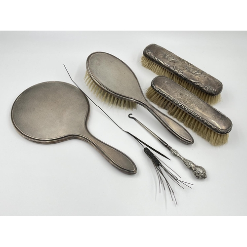 1239 - Five items of hallmarked silver comprising Birmingham hairbrush dated 1961, Birmingham hand mirror d... 