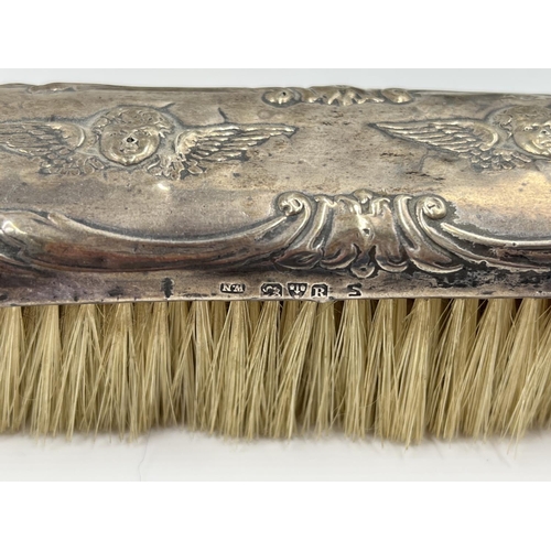 1239 - Five items of hallmarked silver comprising Birmingham hairbrush dated 1961, Birmingham hand mirror d... 