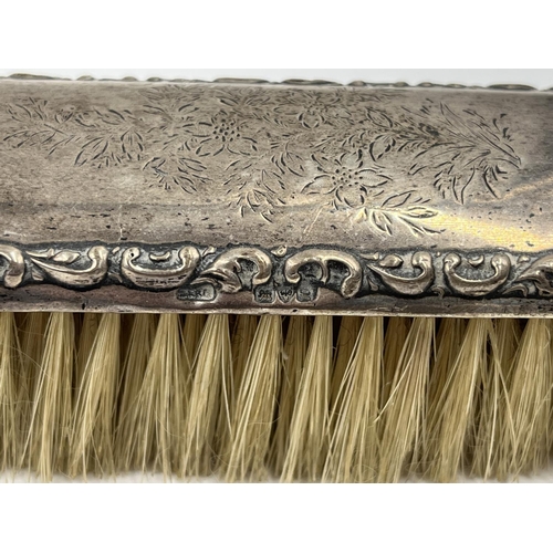 1239 - Five items of hallmarked silver comprising Birmingham hairbrush dated 1961, Birmingham hand mirror d... 