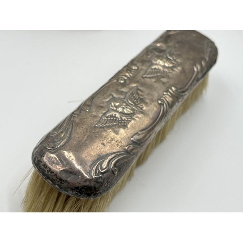 1239 - Five items of hallmarked silver comprising Birmingham hairbrush dated 1961, Birmingham hand mirror d... 