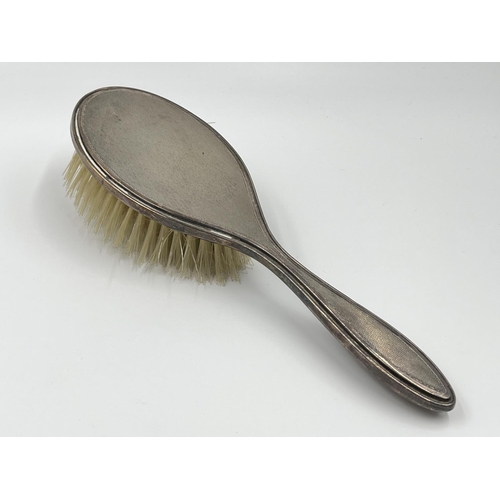 1239 - Five items of hallmarked silver comprising Birmingham hairbrush dated 1961, Birmingham hand mirror d... 