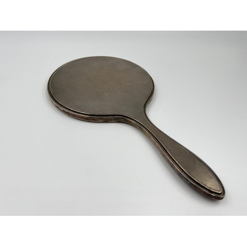 1239 - Five items of hallmarked silver comprising Birmingham hairbrush dated 1961, Birmingham hand mirror d... 