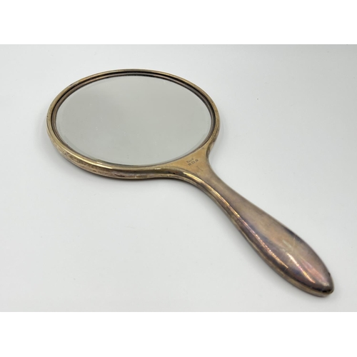 1239 - Five items of hallmarked silver comprising Birmingham hairbrush dated 1961, Birmingham hand mirror d... 