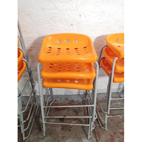 236 - Eleven orange plastic and grey metal stacking stools