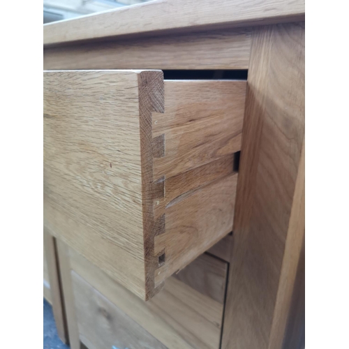 256 - A modern solid oak bedside chest of three drawers - approx. 68cm high x 47cm wide x 40cm deep